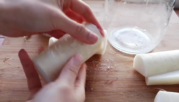 Cut two daikon radishes to fit your container. Liberally rub sea salt on the outside of the radish.