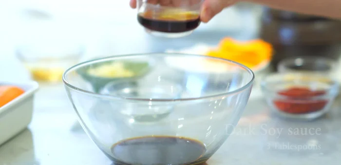 In a large bowl, mix together dark soy sauce, light soy sauce, brown sugar, Korean chili flakes (Gochugaru), chopped garlic, and water.