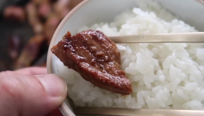 Serve: Slice and serve the cooked pork with rice.