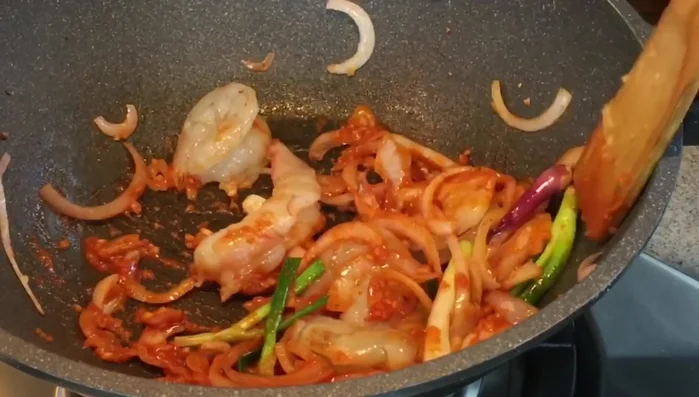Add squid and shrimp/prawns. Stir-fry until almost cooked.