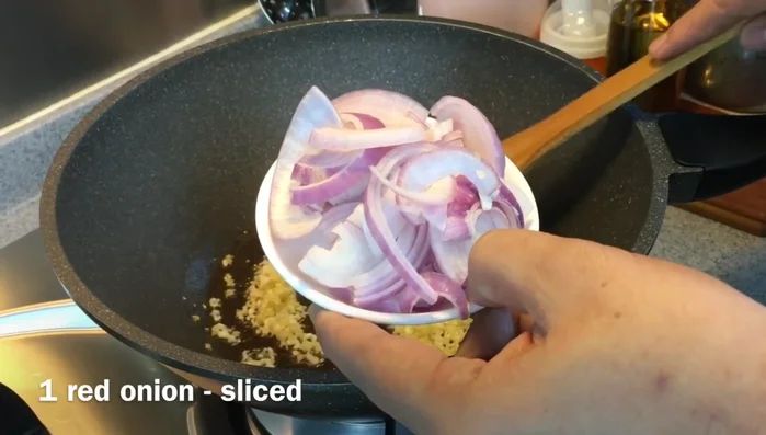 Add sliced onions and cook until softened.