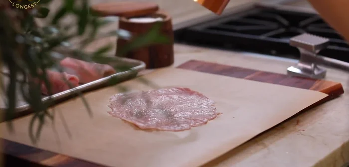 Season and roll: Season the flattened pork with salt and pepper. Place a cheese piece on the pork and roll it tightly like an egg roll. Repeat with the remaining pork and cheese.