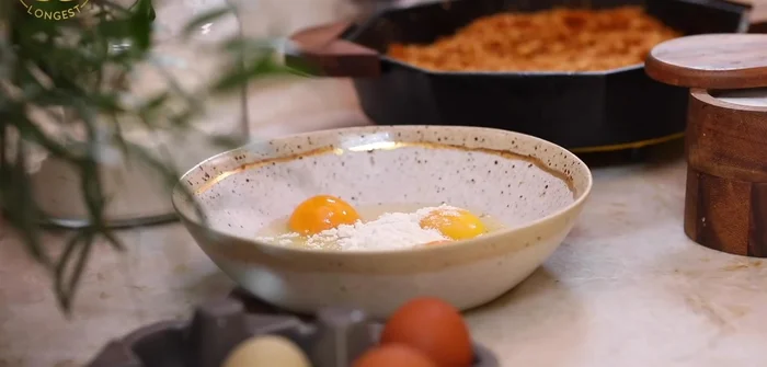 Prepare egg mixture: Whisk together eggs, flour, salt, and pepper.