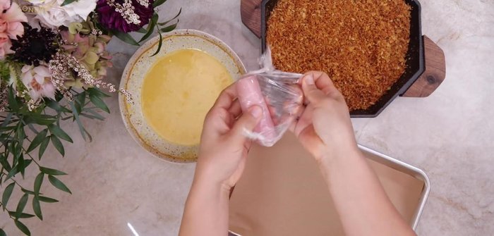 Bread the pork: Dip the frozen pork rolls in the egg mixture, then coat thoroughly with the toasted panko breadcrumbs.