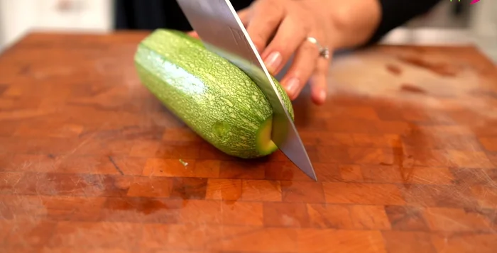 Cut the squash in half lengthwise, then into slices of even thickness (not too thin, not too thick).