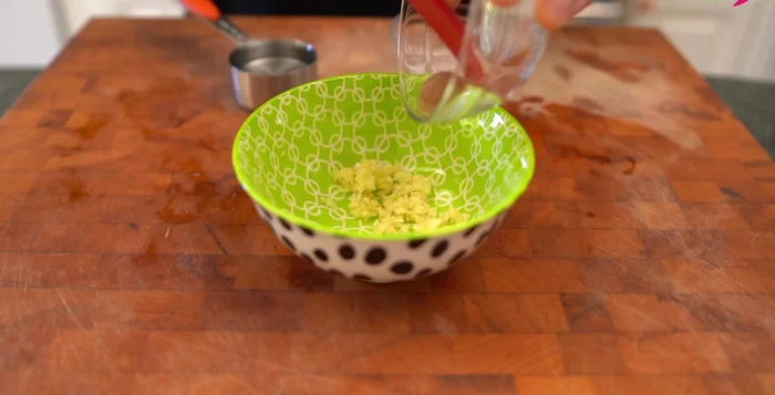 In a bowl, combine the minced garlic, sliced onion, brown sugar, water, and salted shrimp (or salt/fish sauce). Mix well. Set aside.