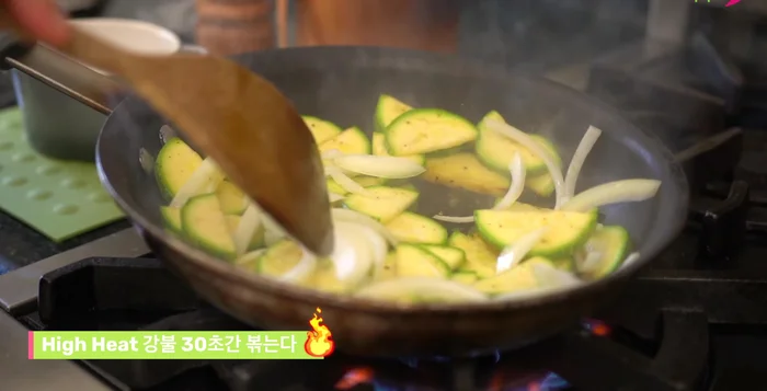 Push the squash to the side of the pan, add the garlic and onion mixture. Stir to heat the liquid for 30 seconds. Reduce heat, mix, and cook until slightly softened. The squash will continue to cook as it rests.