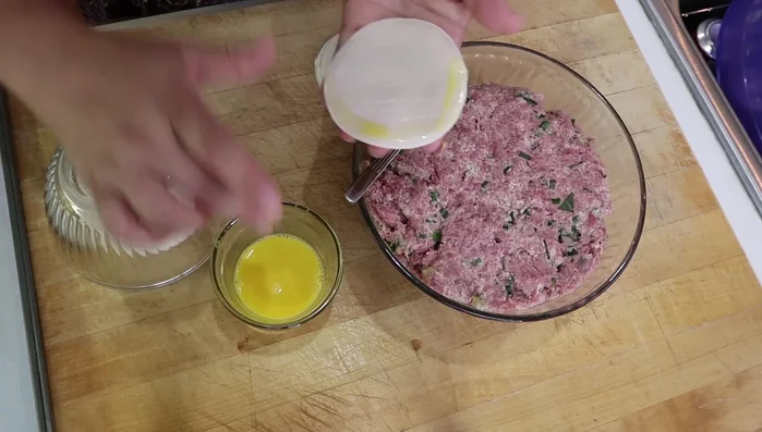 Take a wrapper and brush the edge with egg wash (or water). Add about 1.5 teaspoons of the meat mixture to the center.