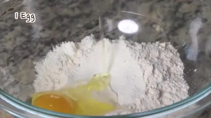 Add the garlic chive sauce to the flour mixture and mix well. The batter should be runny. [146]