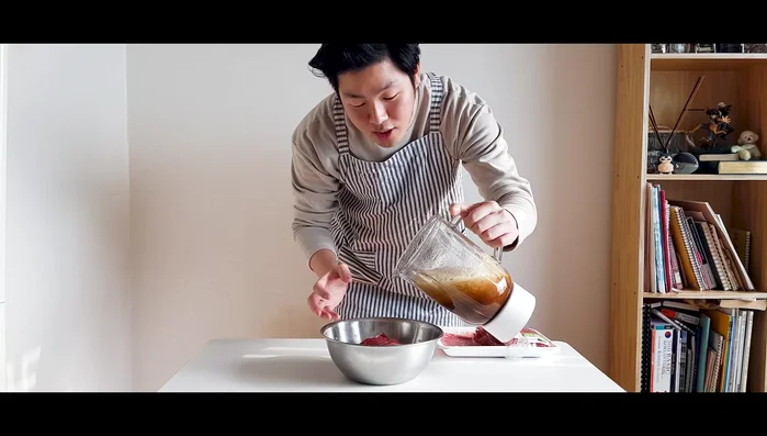Marinate the bulgogi beef (500g) in the prepared sauce. Cover and refrigerate for 30 minutes.