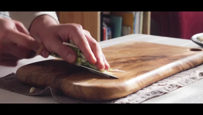 Prepare kimchi by slicing it.