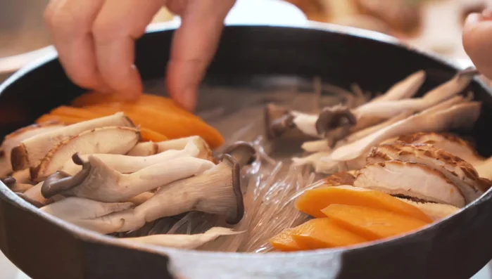 Place the marinated beef in the center of the pot.