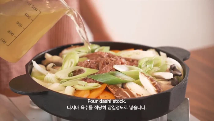 Pour enough dashi stock to cover all the ingredients.