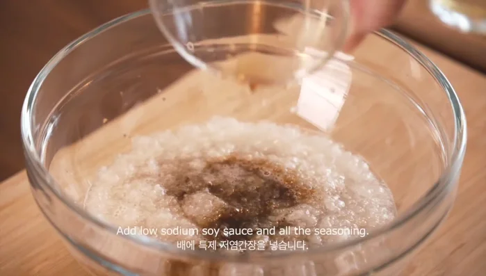 In a bowl, combine the pureed pear, low sodium soy sauce, ginger, sake, sesame oil, and sugar. Mix well. (Exact measurements are in the video description).