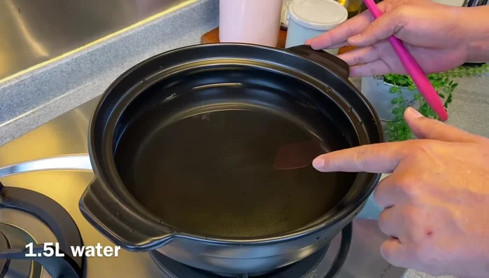 Prepare the soup base: In a clay pot (or normal pot), combine water, soy sauce, garlic, black pepper, chili flakes, and gochujang. Mix well.