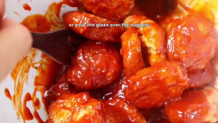 Glaze the cooked nuggets with the sauce. Garnish with sesame seeds. (137.16)