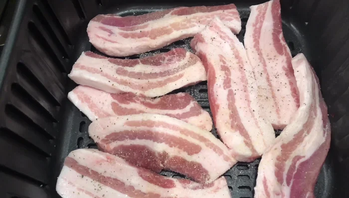 Season pork belly with salt, black pepper, onion powder, and garlic powder.