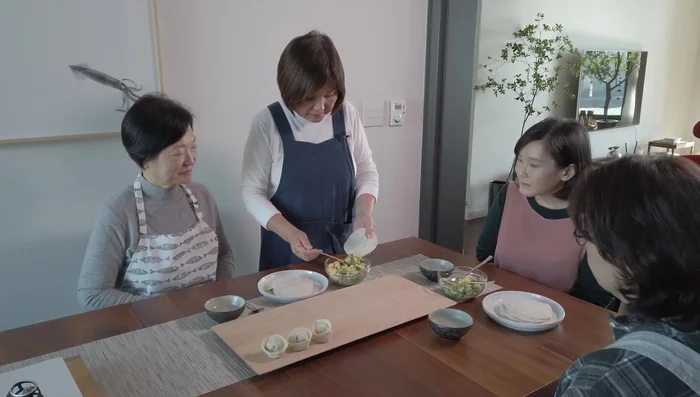 Place a spoonful of the shrimp mixture onto each mandu wrapper. Moisten the edges of the wrapper with water.