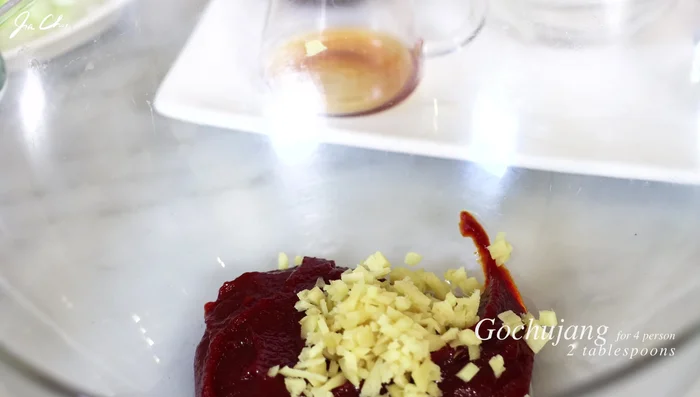 Combine sauce ingredients in a bowl: gochujang, minced ginger and garlic, brown sugar, black pepper, soy sauce, rice wine, optional gochugaru, and sesame oil. [100.88]