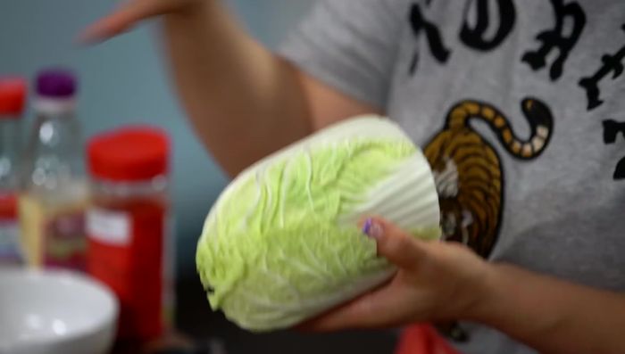 Prepare the napa cabbage by dipping it into the boiling broth for about 1-2 minutes until slightly softened. Remove the dried seaweed once the broth boils.