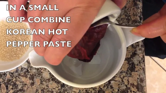 In a small cup, combine Korean hot pepper paste, soy sauce, seasoned rice vinegar, and sesame seeds. Mix well.