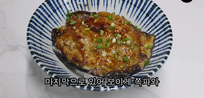 Serve the fried eggplant over hot rice, topped with the seasoned onions, green onions, and pimento peppers.