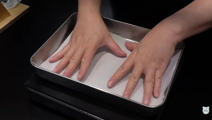 Spread the dough evenly on a baking tray lined with parchment paper. Make sure it's not too thick or thin.
