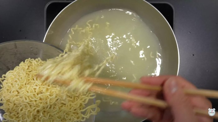 Drain the noodles and add the thinly shredded cabbage.