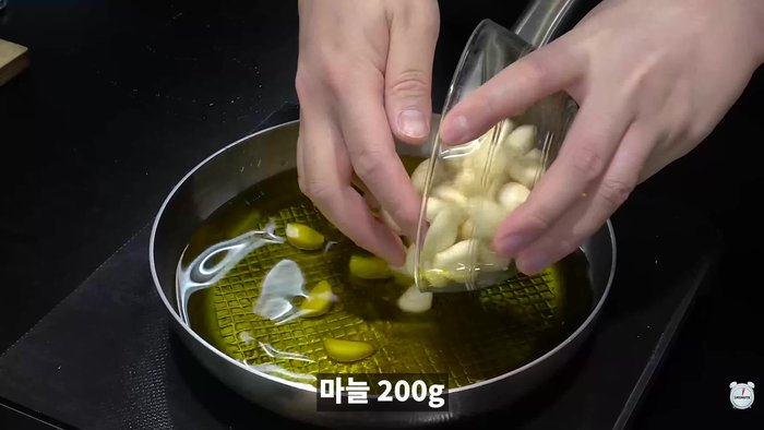 Add whole garlic cloves and fry over low heat until golden brown.