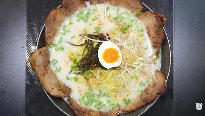 Garnish with green onions, half-boiled eggs, minced garlic, and shichimi.
