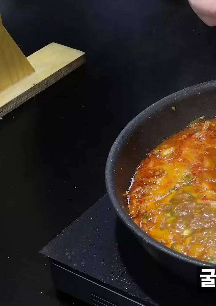 Add soy sauce, mirin, corn syrup, doenjang, chicken stock, oyster sauce, chopped garlic, and various chili peppers. Add specialty water to adjust consistency.