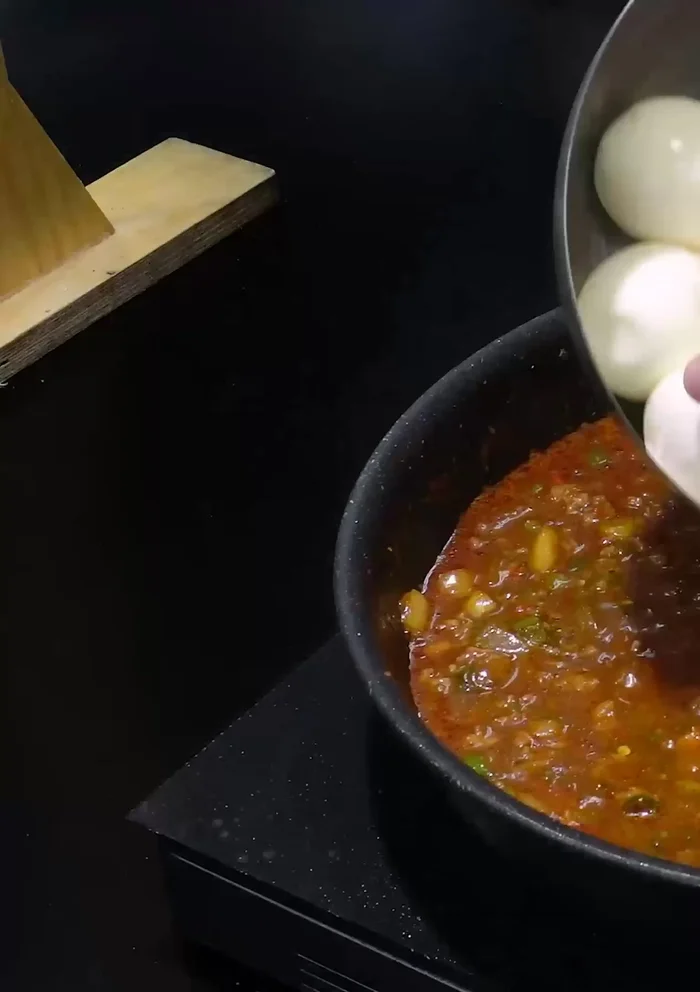 Add the peeled eggs to the pan and simmer for exactly 1 minute more.