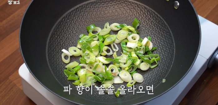 Add the carrots, green peppers, and onions. Stir-fry lightly.