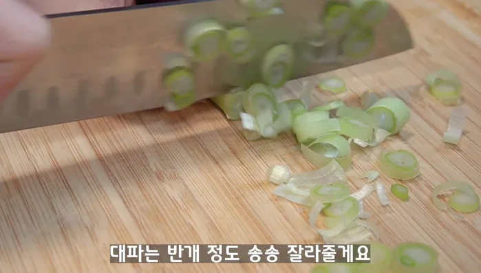 Start by adding Spam into the pot. Add other ingredients such as Kimchi, Onion, Garlic, etc.