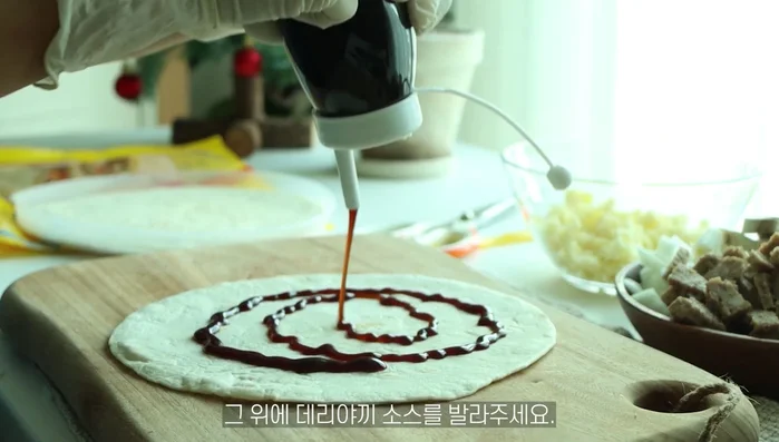 Spread teriyaki sauce on a tortilla.