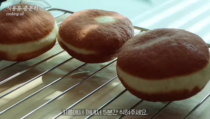 Remove from oil, let cool for 5 minutes, and coat with powdered sugar.