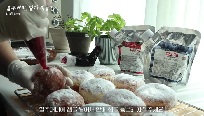 Insert a knife to create space for the jam, then fill with jam using a piping bag.