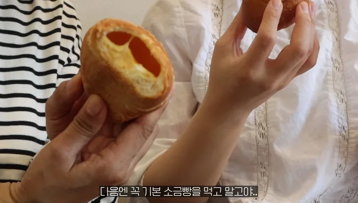 Baking or cooking the bread dip. The wife's presence is mentioned.