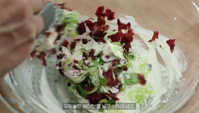 Add the cream cheese, green onions, and fried bacon to the bowl and mix.