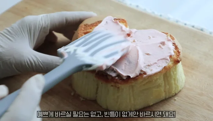 Spread whipped cream evenly on the outside of one castella slice. Squeeze more whipped cream from a piping bag, ensuring no gaps are left.