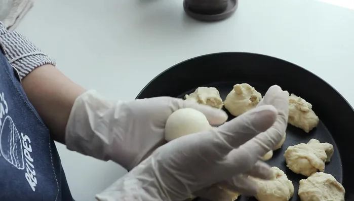 Shape each portion into a round shape. Attach bananas (optional).