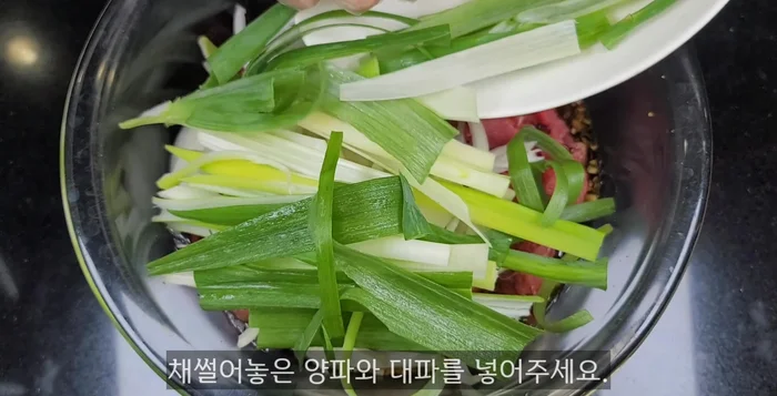 Combine marinated bulgogi, sliced onions, and green onions. Refrigerate for at least a day for best results.