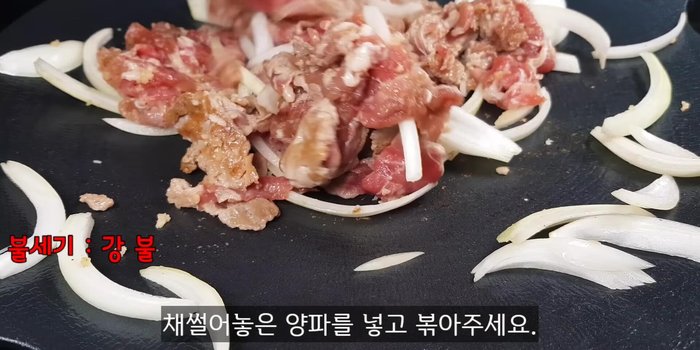Add the onions to prevent burning and continue stir-frying.