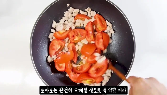 Add tomatoes and stir-fry until they are completely crushed. Cover with a lid if available.