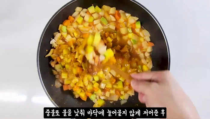 Add curry powder, stirring to prevent clumping. Lower heat and stir continuously to prevent sticking.