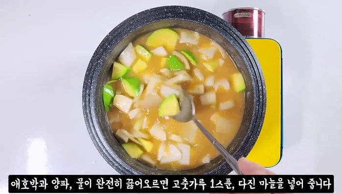 Once zucchini and onion are cooked, add red pepper powder, minced garlic, potatoes (if using), and red pepper.