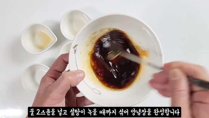 In a separate bowl, mix soy sauce, tuna fish sauce, sugar, sesame oil, and water until sugar dissolves.