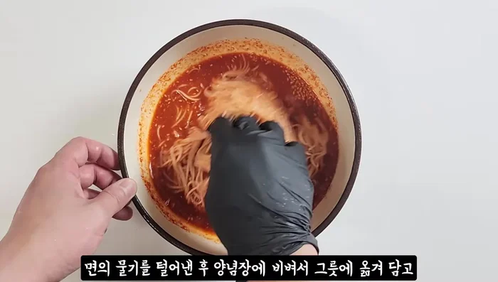 Mix noodles with the seasoning sauce and transfer to a bowl. Coat the onions with the remaining sauce.