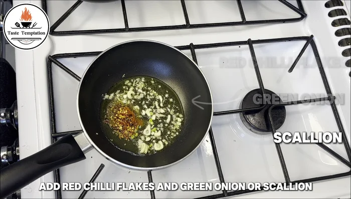 Add red chili flakes and green onion/scallion to the garlic oil.