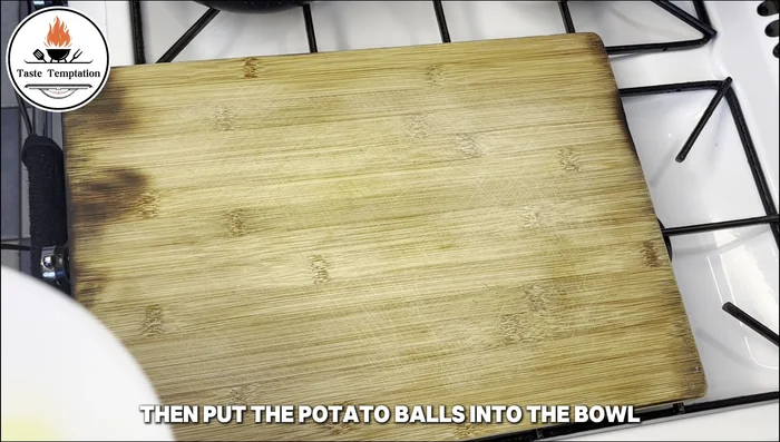 Add the boiled potato balls to the chili oil.